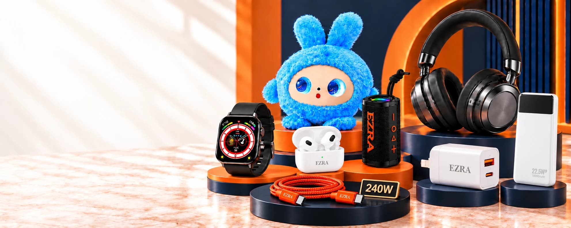 X-TECH collection on navy and orange displays: headphones, smartwatch, blue toy, earbuds, speaker, orange 240W cable, wall charger and power bank together